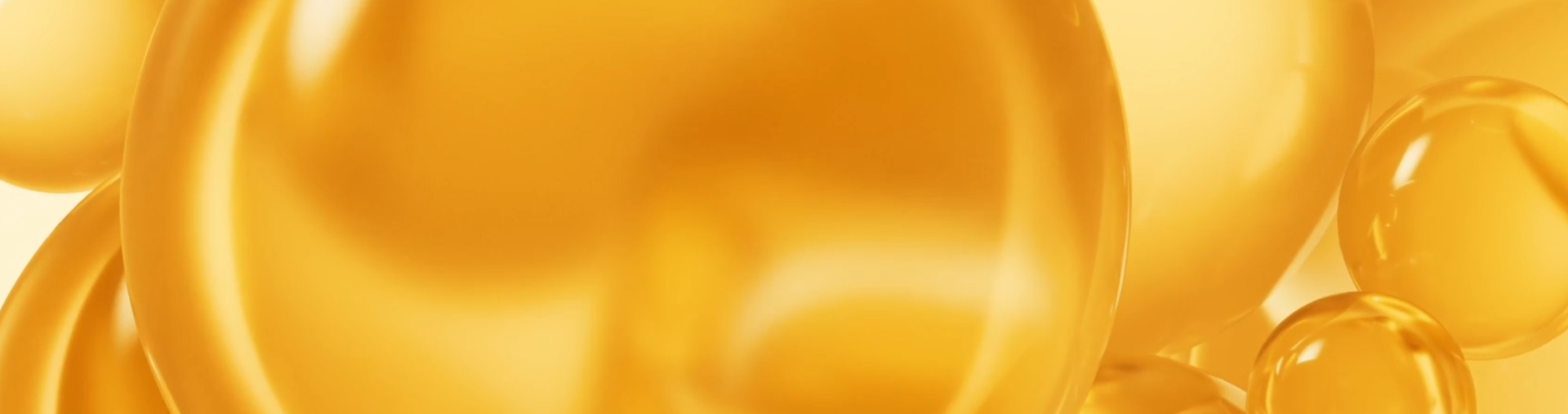 Golden translucent spheres and bubbles floating against a warm yellow background