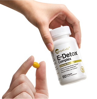 Two hands holding MegaGold E-Detox Complex supplement bottle and yellow softgel capsule