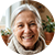 Smiling older woman with white hair, warm expression, circular crop